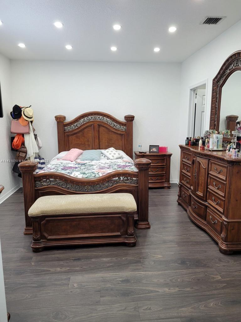 16383 Southwest 44th Terrace Miami, FL 33185 - Photo 18 of 24 a bedroom with bed and wooden floor