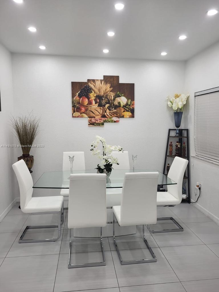 16383 Southwest 44th Terrace Miami, FL 33185 - Photo 5 of 24 a living room with couches and a painting on the wall
