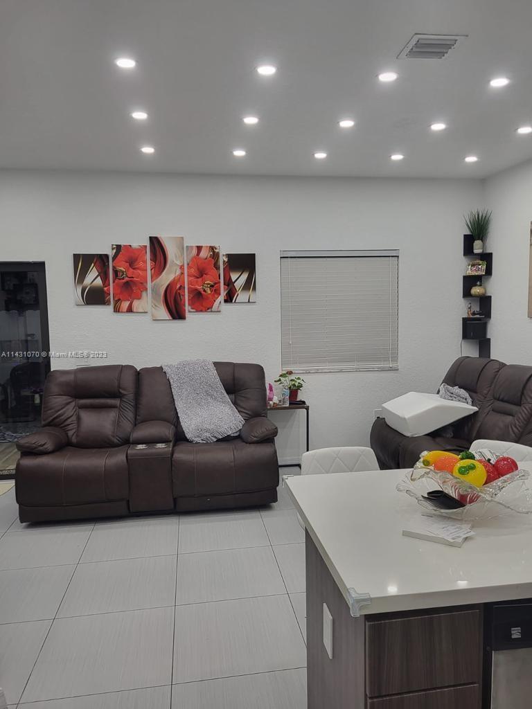 16383 Southwest 44th Terrace Miami, FL 33185 - Photo 6 of 24 a living room with furniture and a table