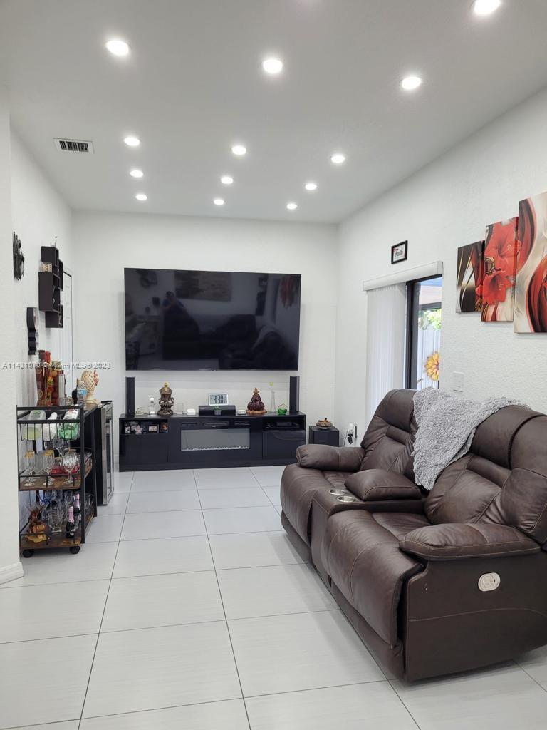 16383 Southwest 44th Terrace Miami, FL 33185 - Photo 10 of 24 a living room with furniture and a flat screen tv
