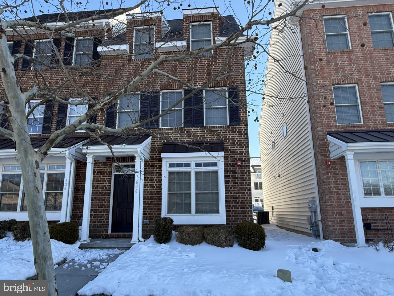 a view of a brick house with many windows