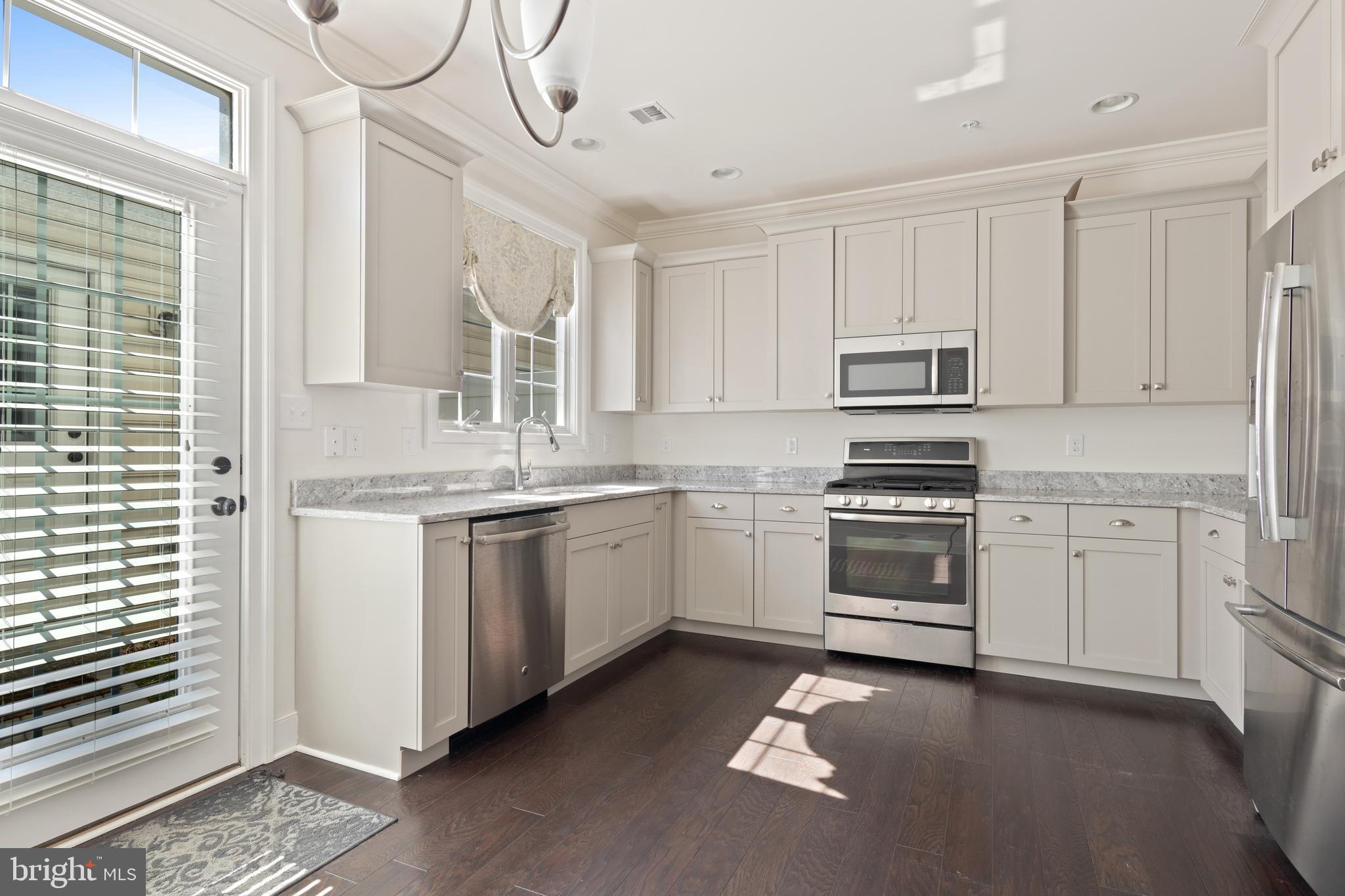 626 D Street Kennett Square, PA 19348 - Photo 11 of 24 a kitchen with white cabinets and white appliances