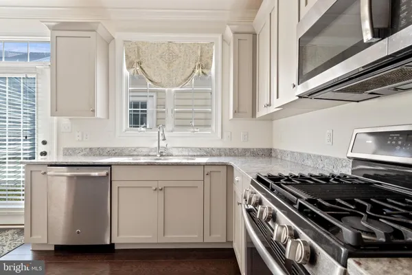 a kitchen with granite countertop a stove and a sink