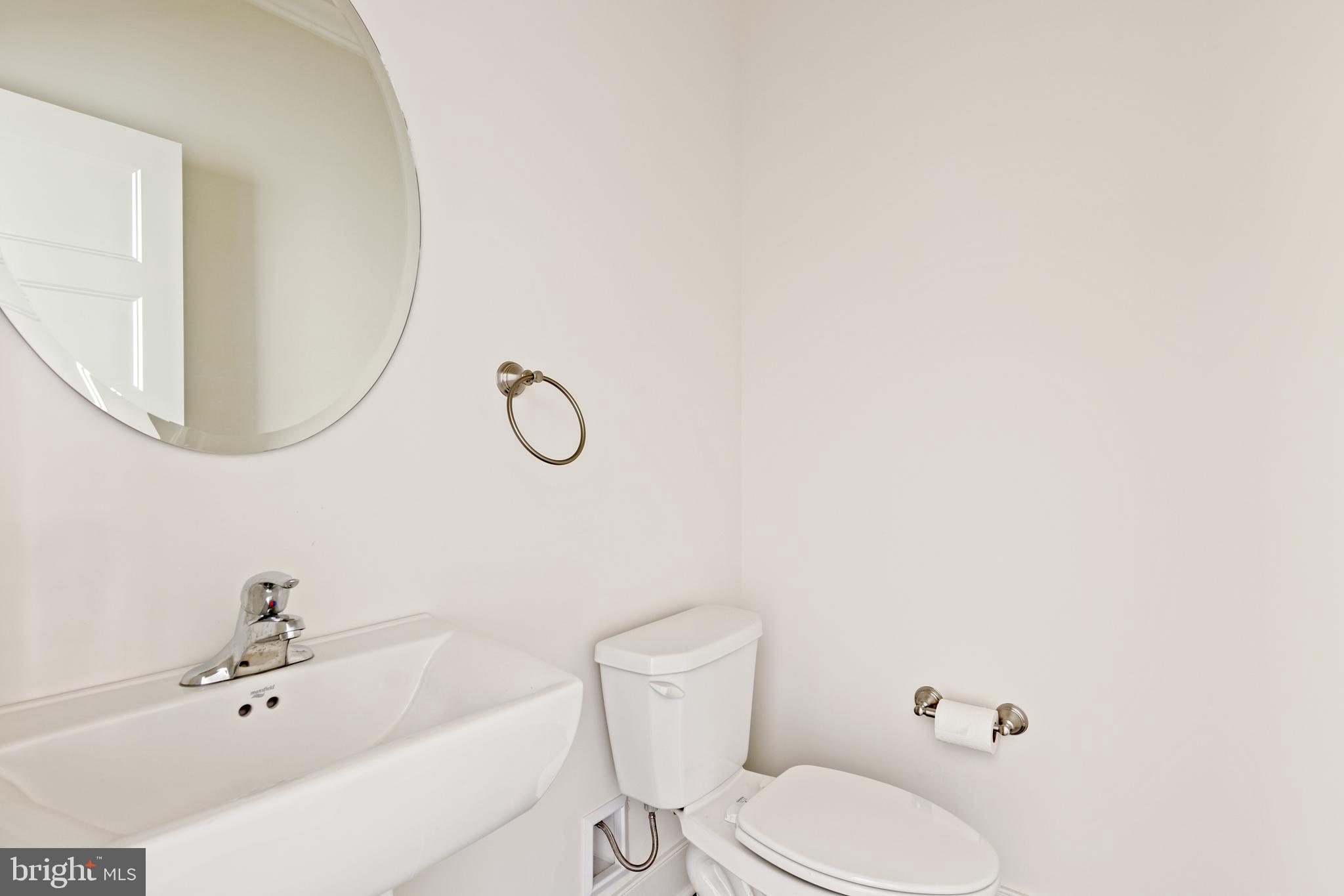 626 D Street Kennett Square, PA 19348 - Photo 14 of 24 a bathroom with a sink a toilet and mirror