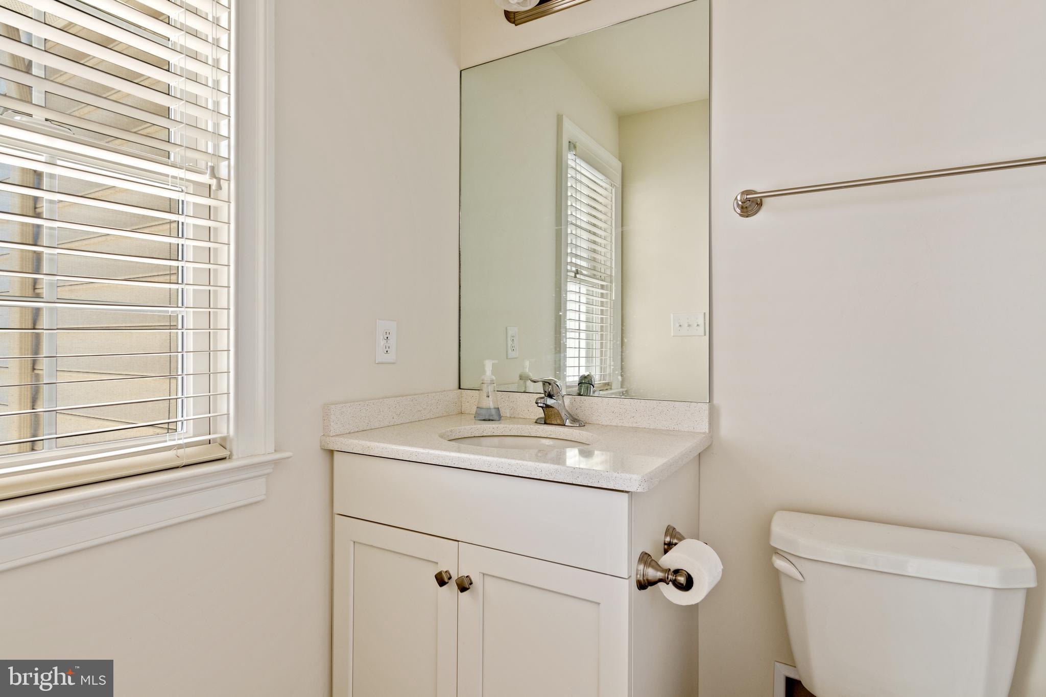 626 D Street Kennett Square, PA 19348 - Photo 20 of 24 a bathroom with a sink a toilet and a mirror