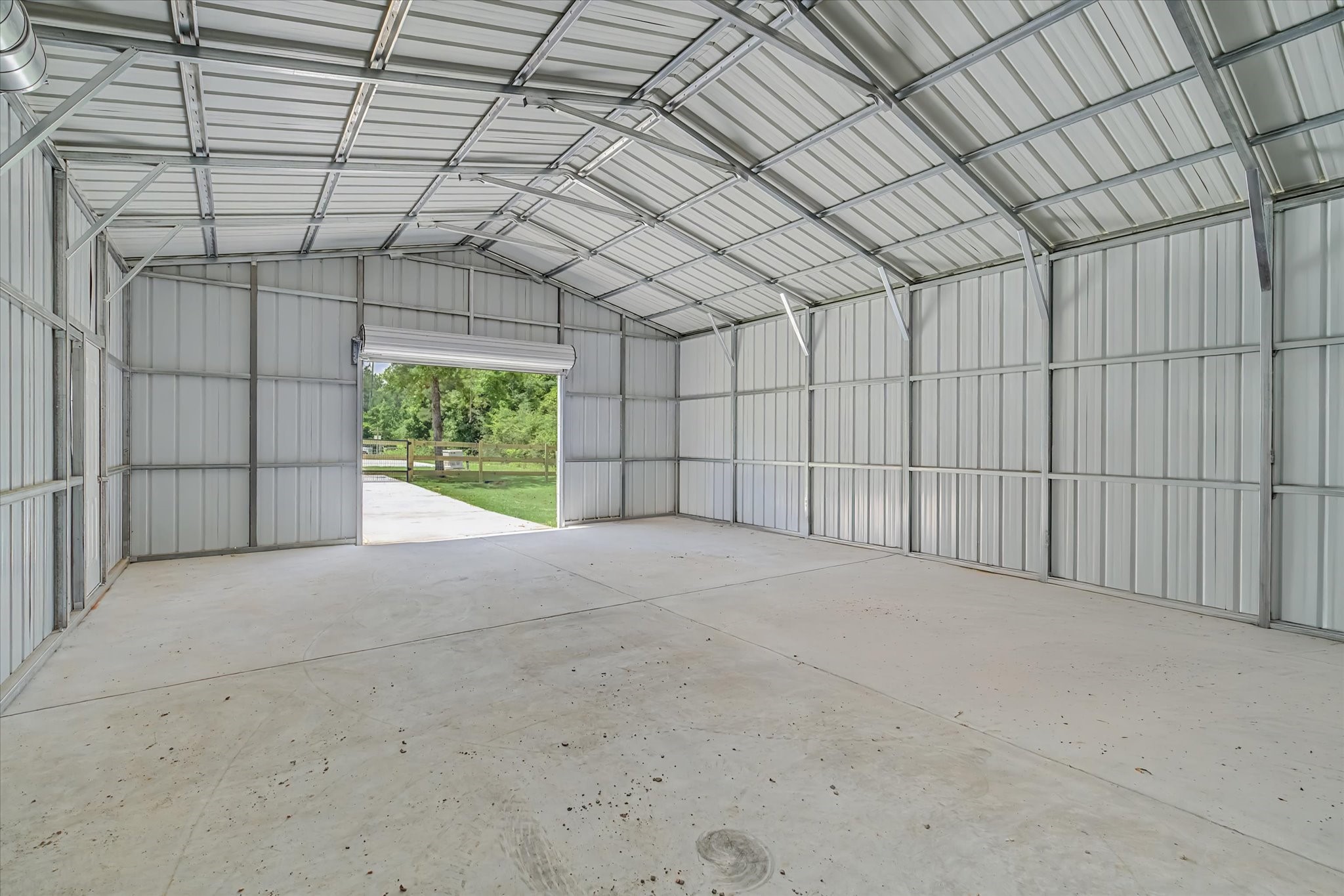 347 Iron Horse Road Willis, TX 77378 - Photo 33 of 49 South rollup door, 9' wide by 8' high