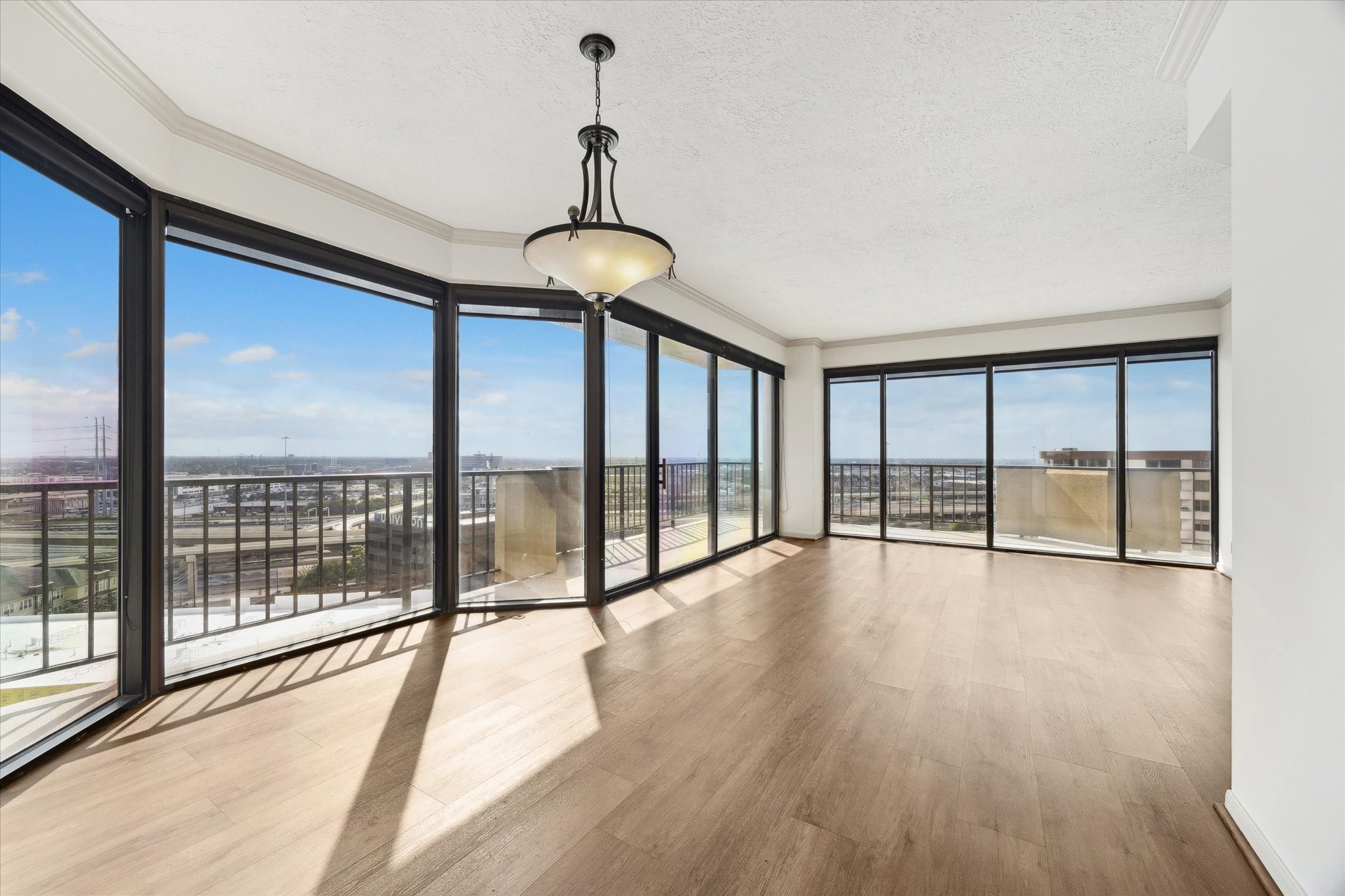 3350 McCue Road, Unit 1501 Houston, TX 77056 - Photo 3 of 38 a view of an empty room with wooden floor and a window