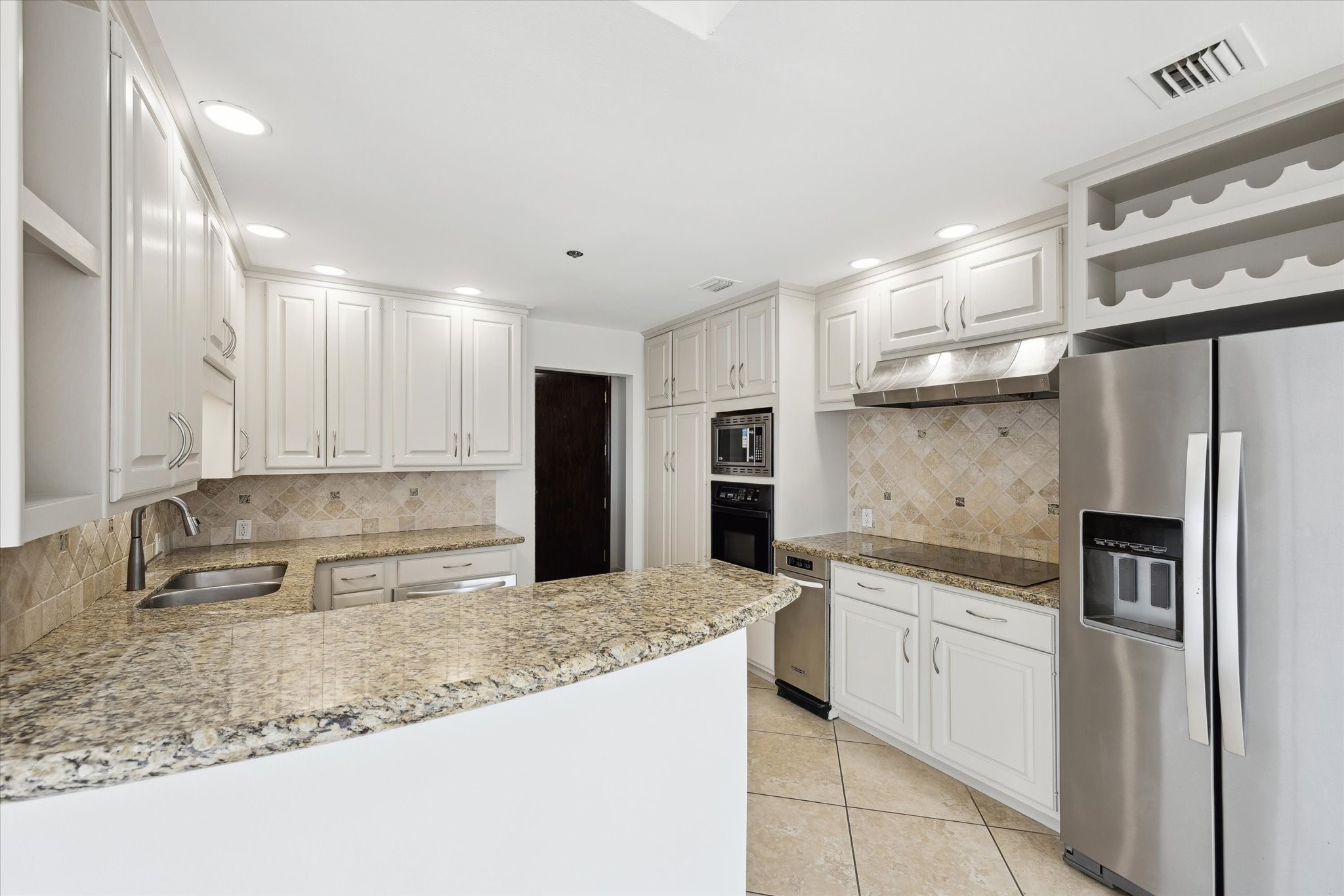 3350 McCue Road, Unit 1501 Houston, TX 77056 - Photo 7 of 38 a kitchen with stainless steel appliances granite countertop a sink stove and refrigerator