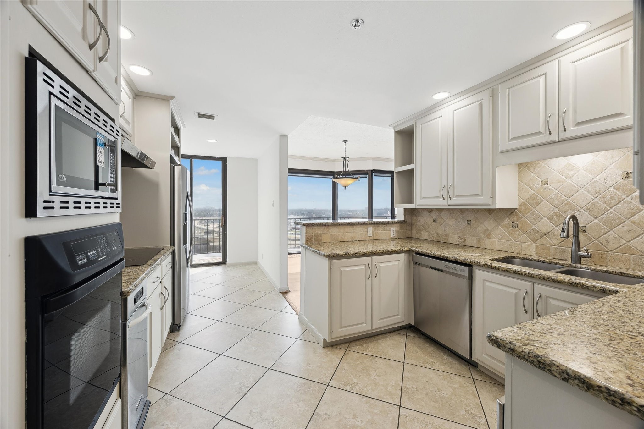3350 McCue Road, Unit 1501 Houston, TX 77056 - Photo 8 of 38 a kitchen with stainless steel appliances granite countertop a sink stove and cabinets