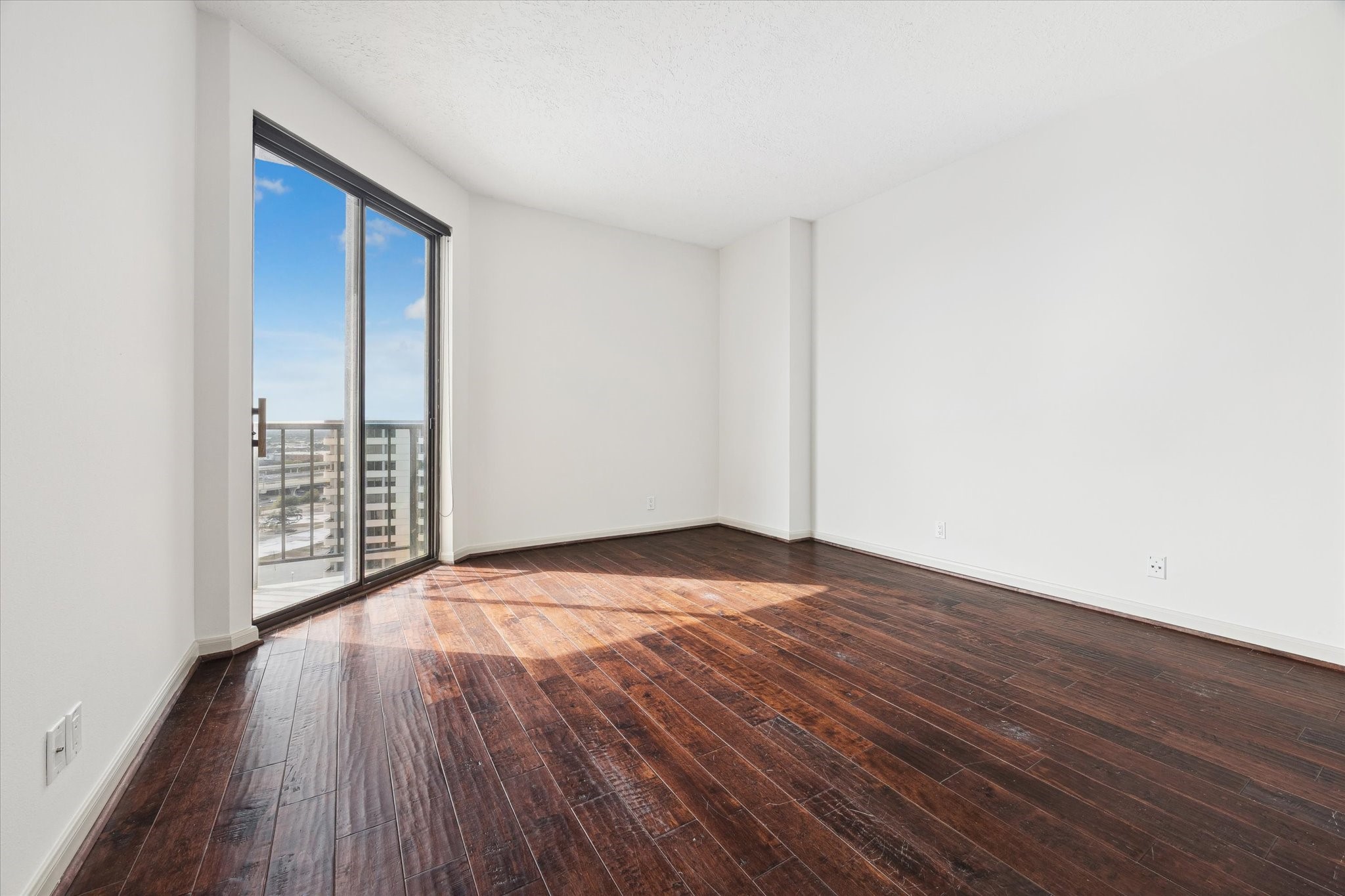 3350 McCue Road, Unit 1501 Houston, TX 77056 - Photo 10 of 38 a view of an empty room with wooden floor