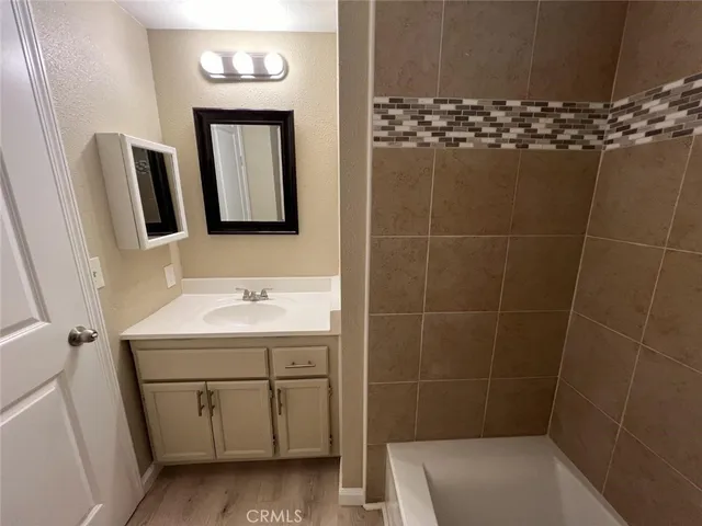 a bathroom with a tub a toilet and a shower