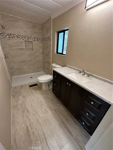 a bathroom with a toilet a sink and shower
