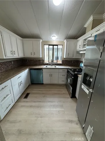 an empty room with wooden floor and closet area