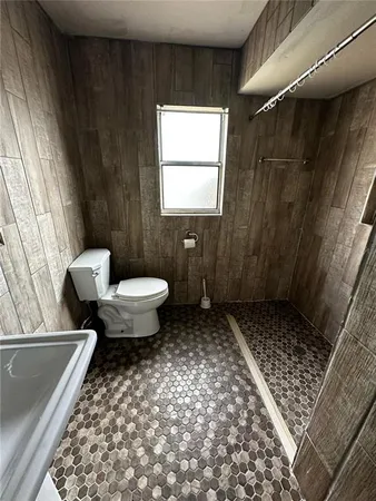 an empty room with a ceiling fan and window