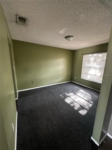 a view of a livingroom with a ceiling fan and window