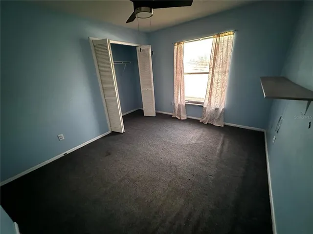 a large tree in front of a house