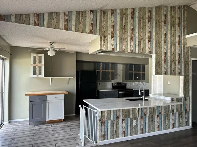 a view of a room with wooden floor