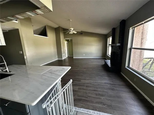 a view of kitchen with sink and wooden floor