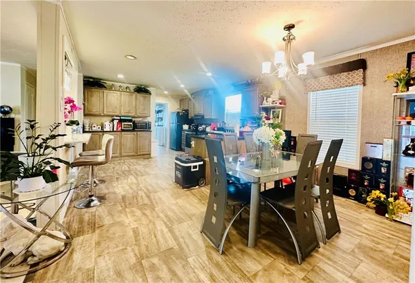 a view of a dining room with furniture and chandelier
