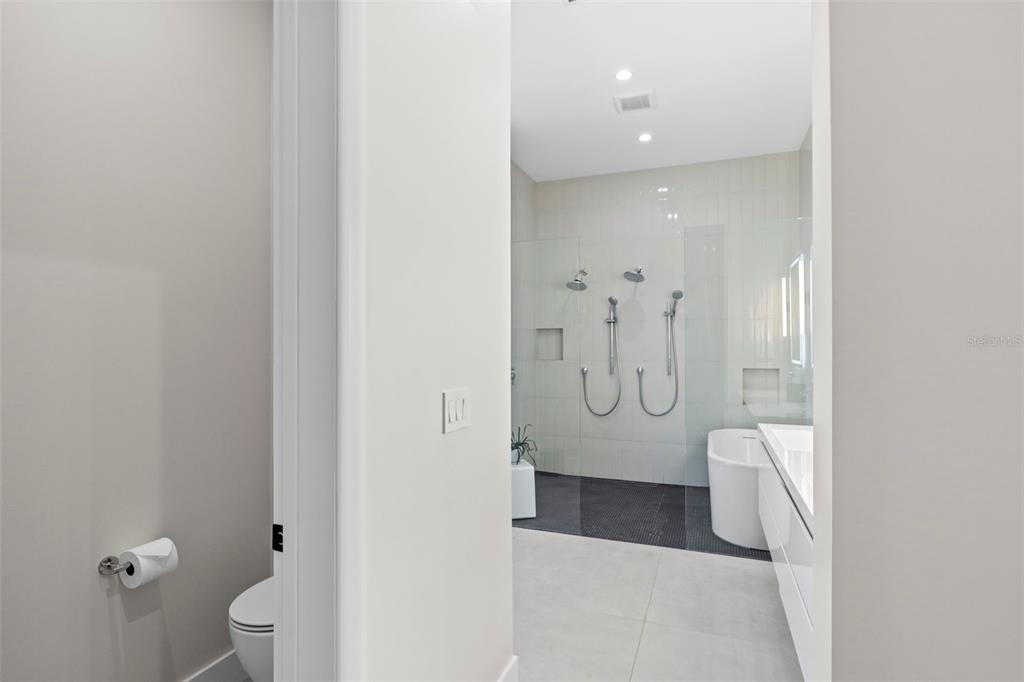 1304 Indian Rocks Road Belleair, FL 33756 - Photo 34 of 80 a bathroom with a glass shower door