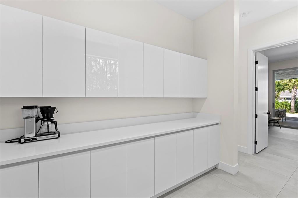 1304 Indian Rocks Road Belleair, FL 33756 - Photo 53 of 80 a kitchen with white cabinets and sink