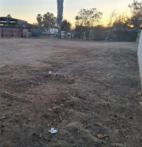 a view of dirt road with a building in the background