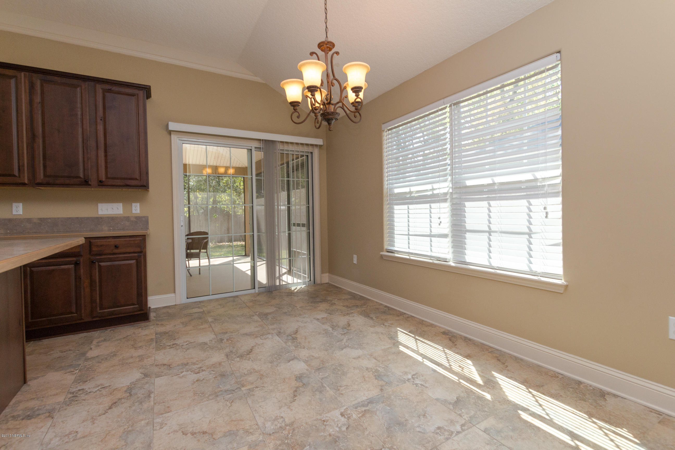 12865 Beaubien Road Jacksonville, FL 32258 - Photo 13 of 28 a spacious en suite bathroom with a granite countertop sink a large mirror and a window