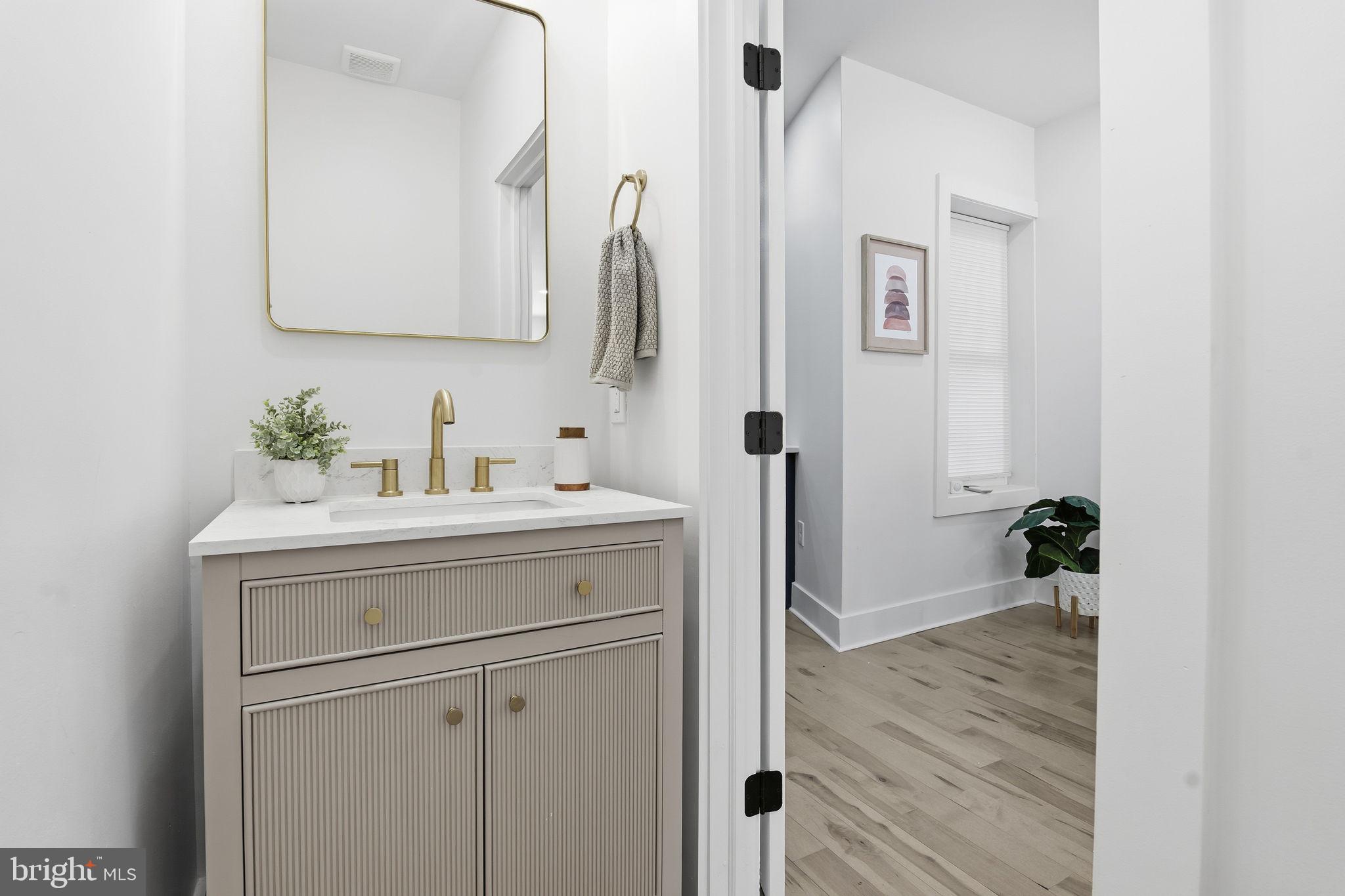 1742 East Oliver Street Baltimore, MD 21213 - Photo 11 of 36 a bathroom with a sink and a mirror