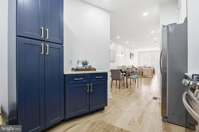 a kitchen with a refrigerator and a table