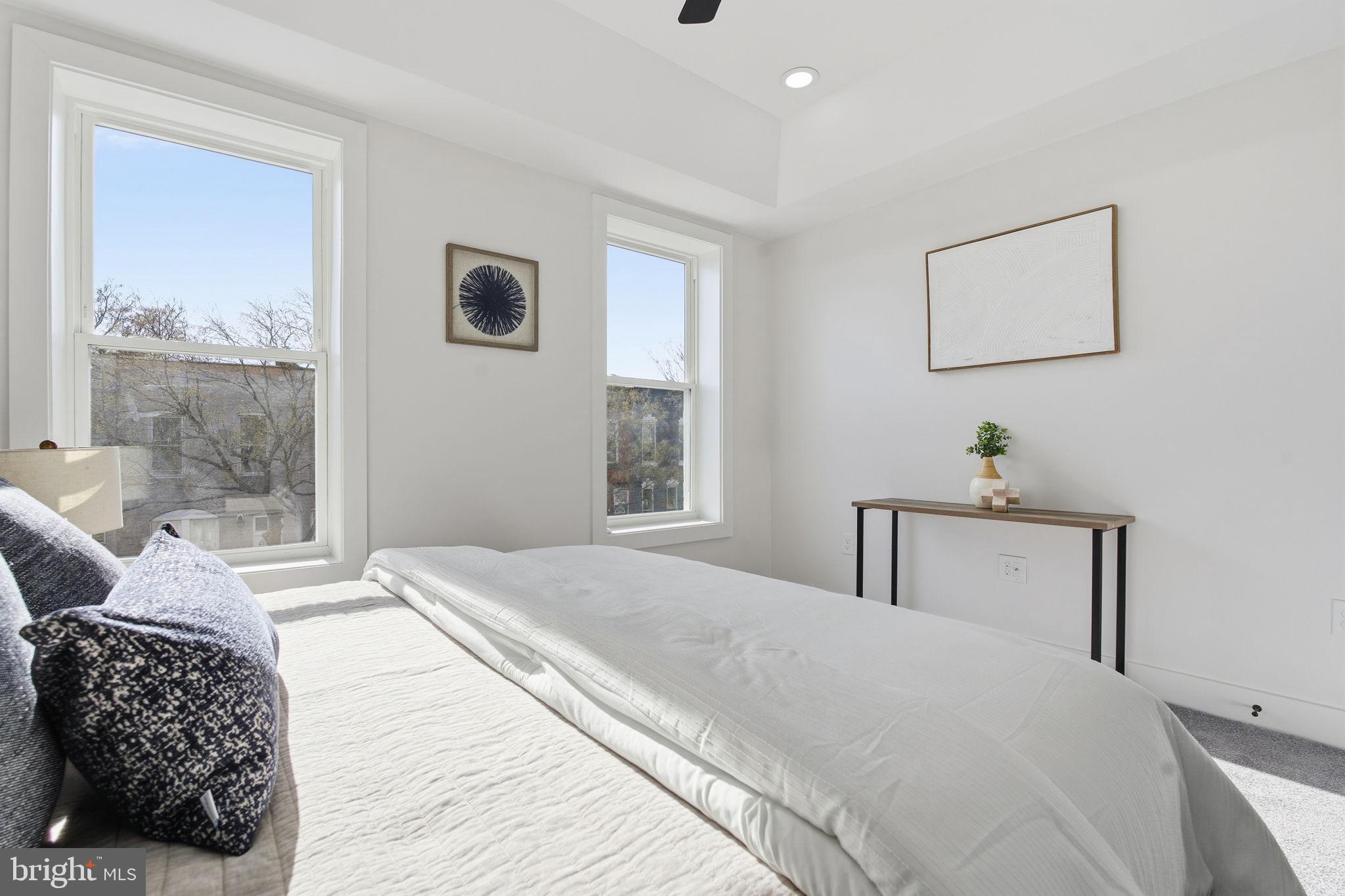 1742 East Oliver Street Baltimore, MD 21213 - Photo 18 of 36 a bedroom with a large bed and a window