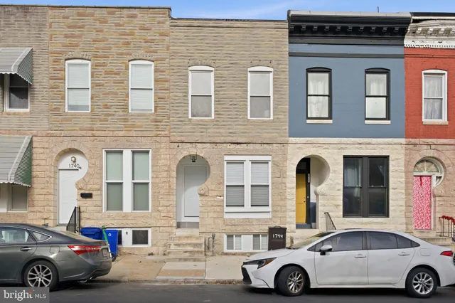 a car parked in front of a brick building