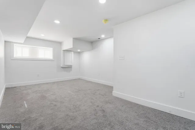 an empty room with a empty space and windows