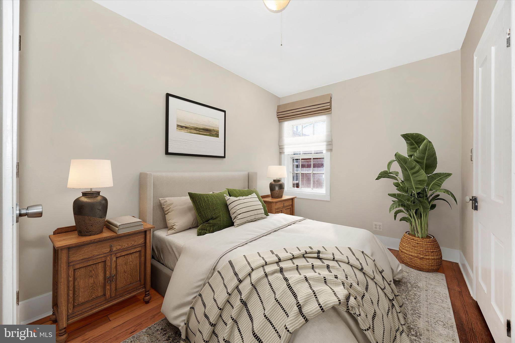 20 East 4th Street Frederick, MD 21701 - Photo 11 of 55 a bedroom with a large bed and a potted plant