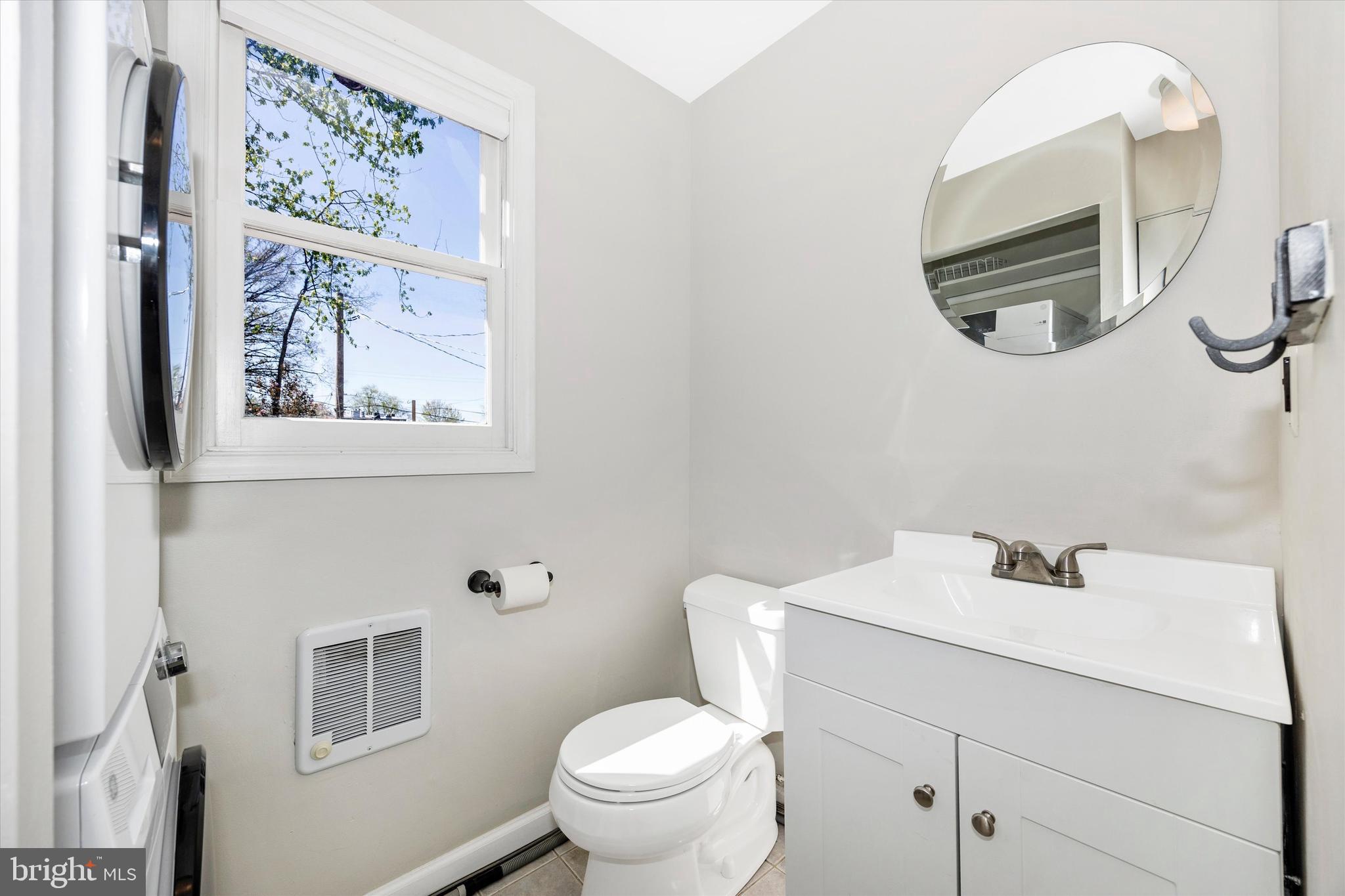 20 East 4th Street Frederick, MD 21701 - Photo 17 of 55 a bathroom with a toilet a sink and mirror