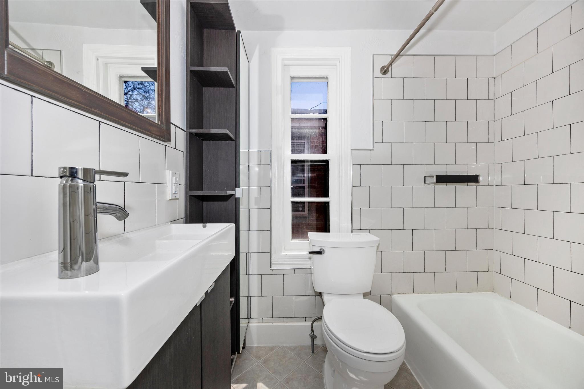 20 East 4th Street Frederick, MD 21701 - Photo 20 of 55 a bathroom with a sink a toilet and shower
