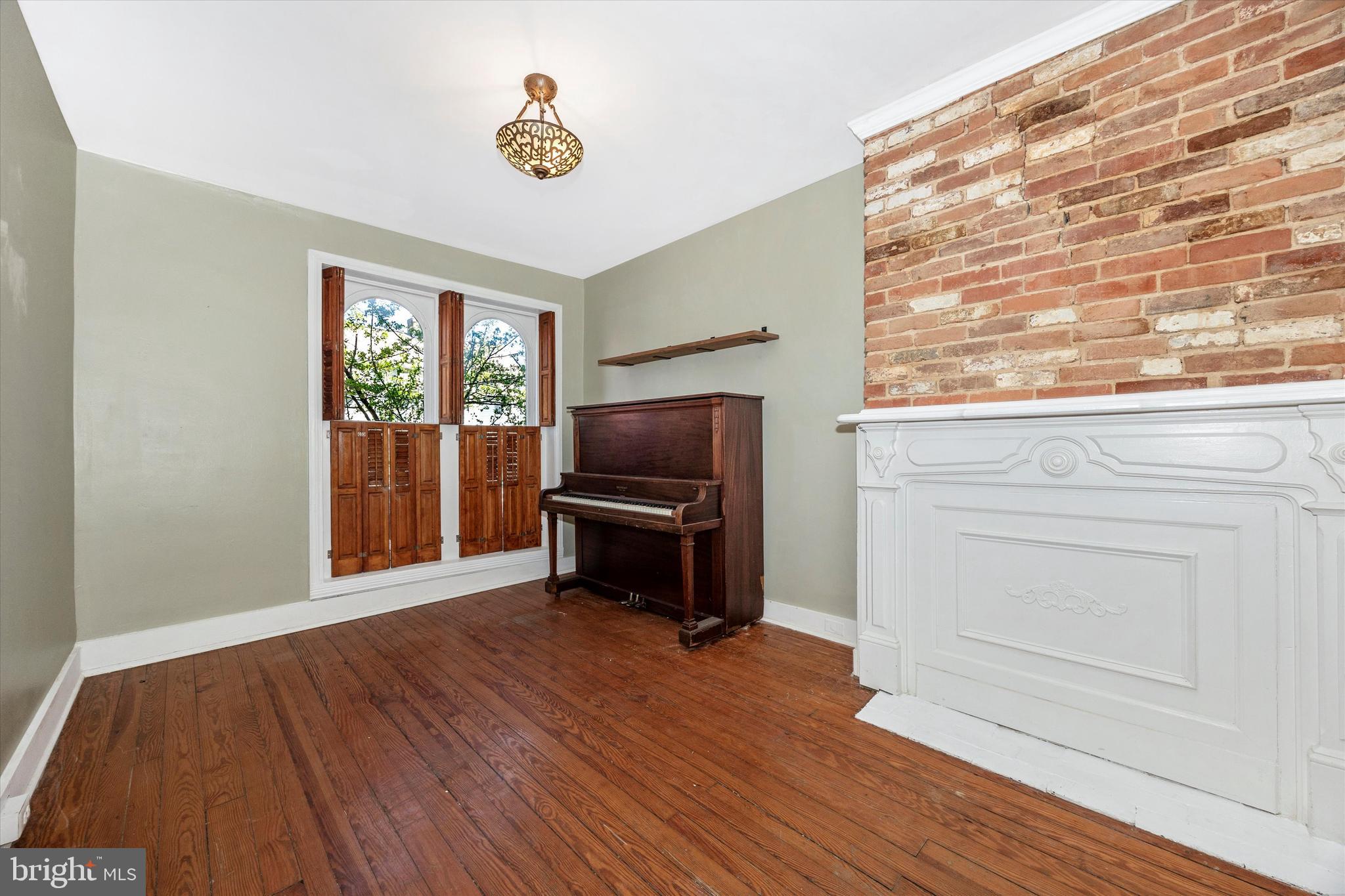20 East 4th Street Frederick, MD 21701 - Photo 25 of 55 a living room with a flat screen tv dressers and a chandelier