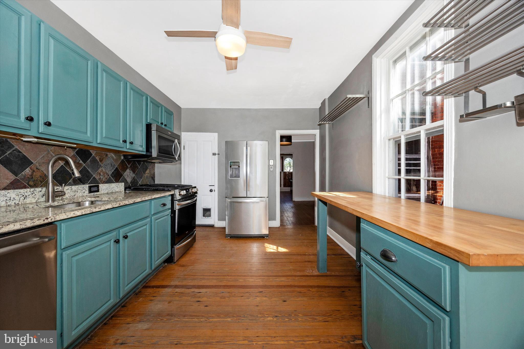 20 East 4th Street Frederick, MD 21701 - Photo 33 of 55 a kitchen with stainless steel appliances granite countertop a sink counter space cabinets and a large window