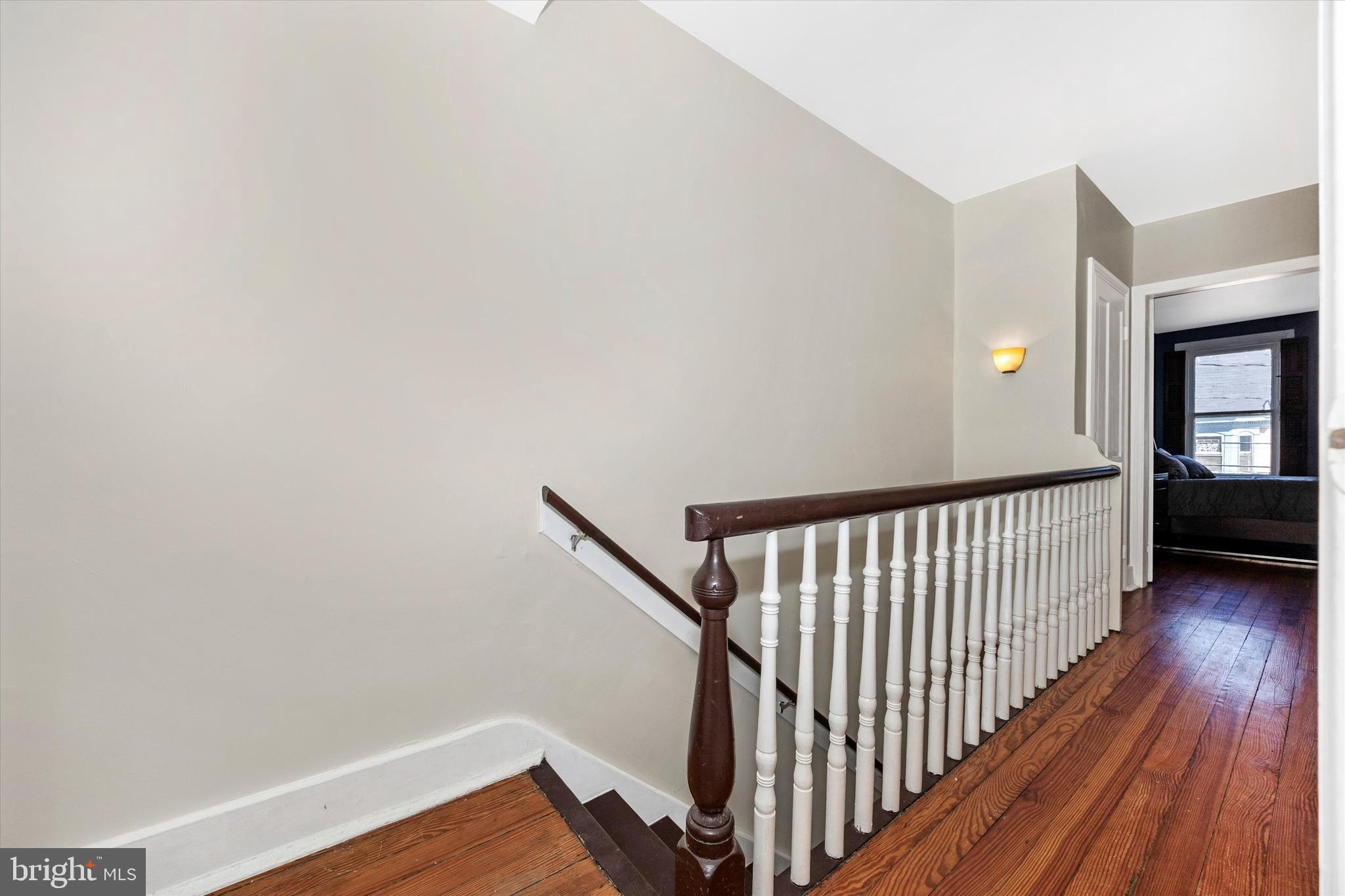 20 East 4th Street Frederick, MD 21701 - Photo 37 of 55 a view of a hallway with wooden floor and staircase