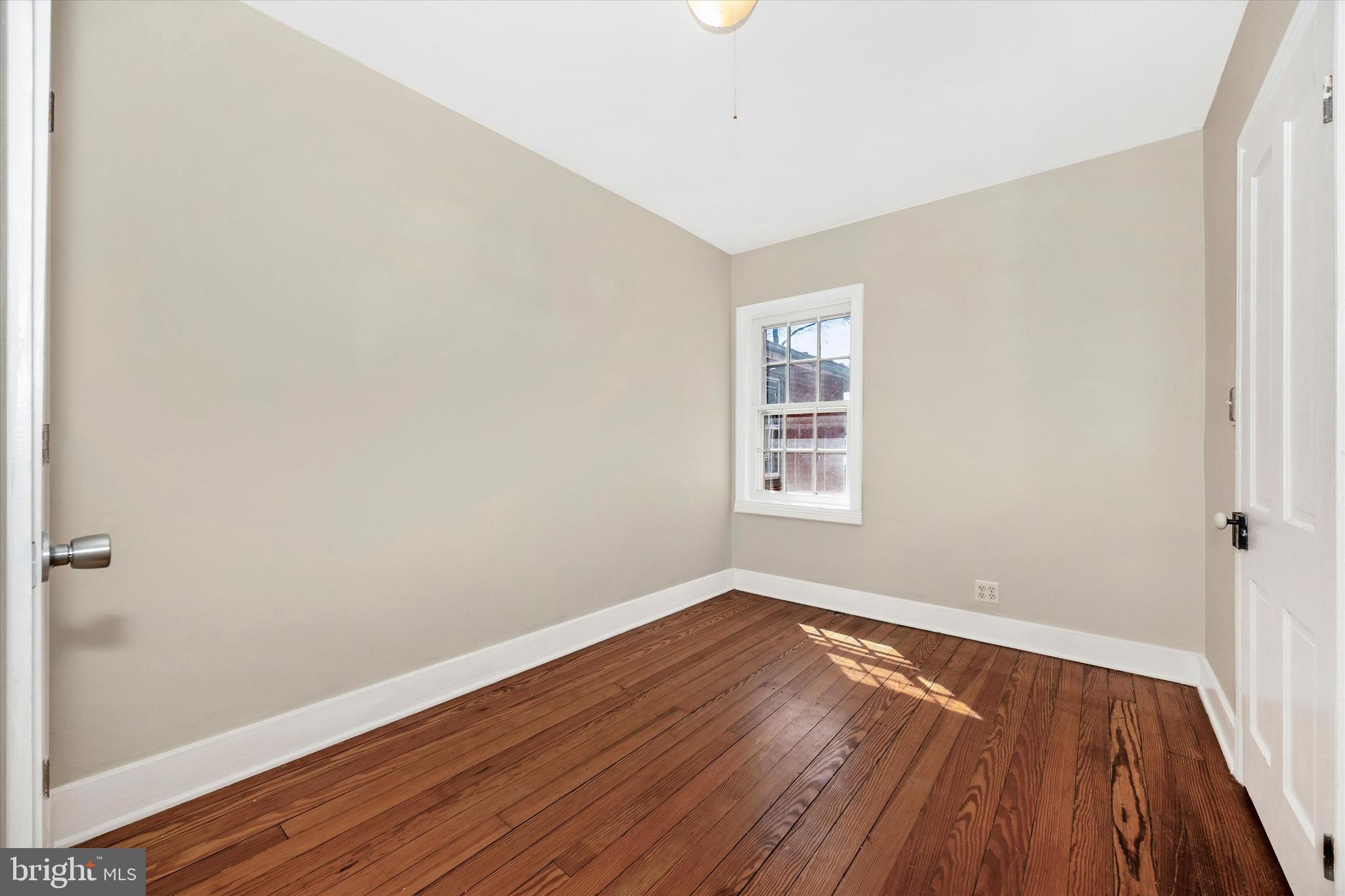 20 East 4th Street Frederick, MD 21701 - Photo 41 of 55 an empty room with wooden floor and windows