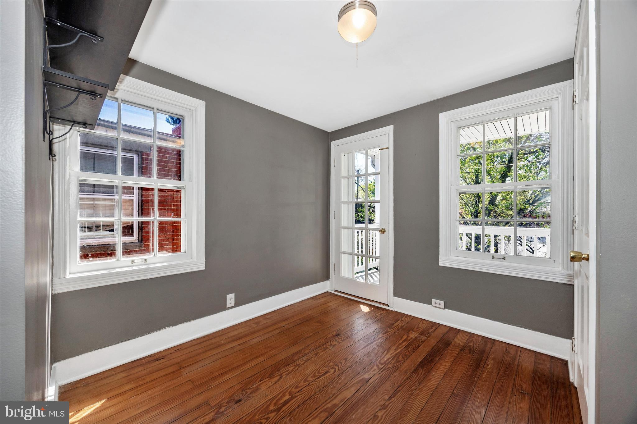 20 East 4th Street Frederick, MD 21701 - Photo 43 of 55 an empty room with wooden floor and windows