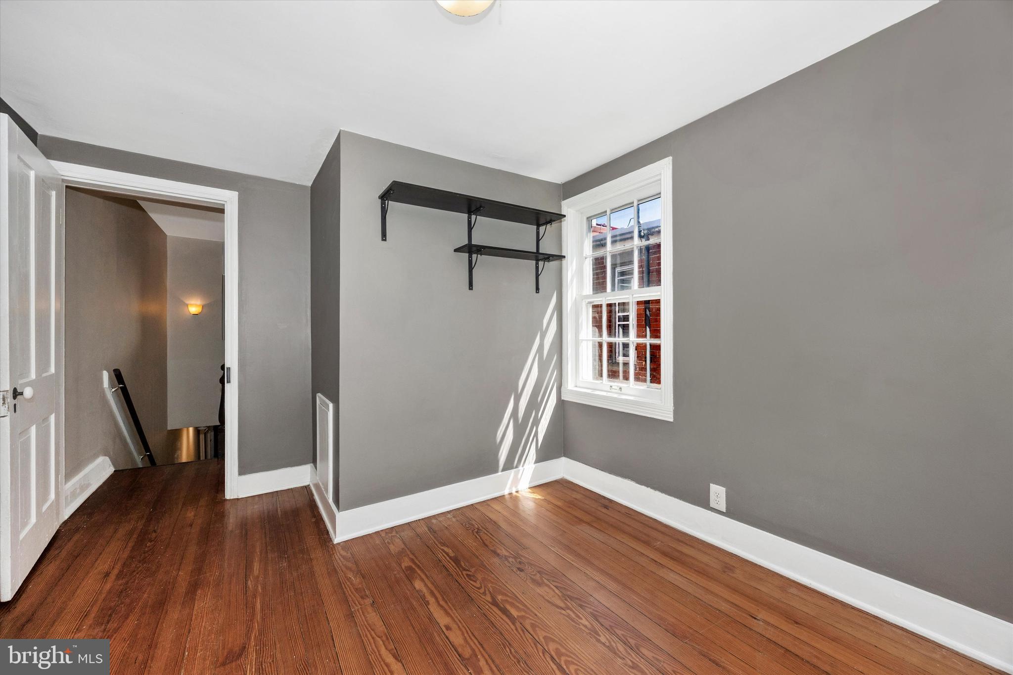 20 East 4th Street Frederick, MD 21701 - Photo 44 of 55 a view of an empty room with wooden floor and a window