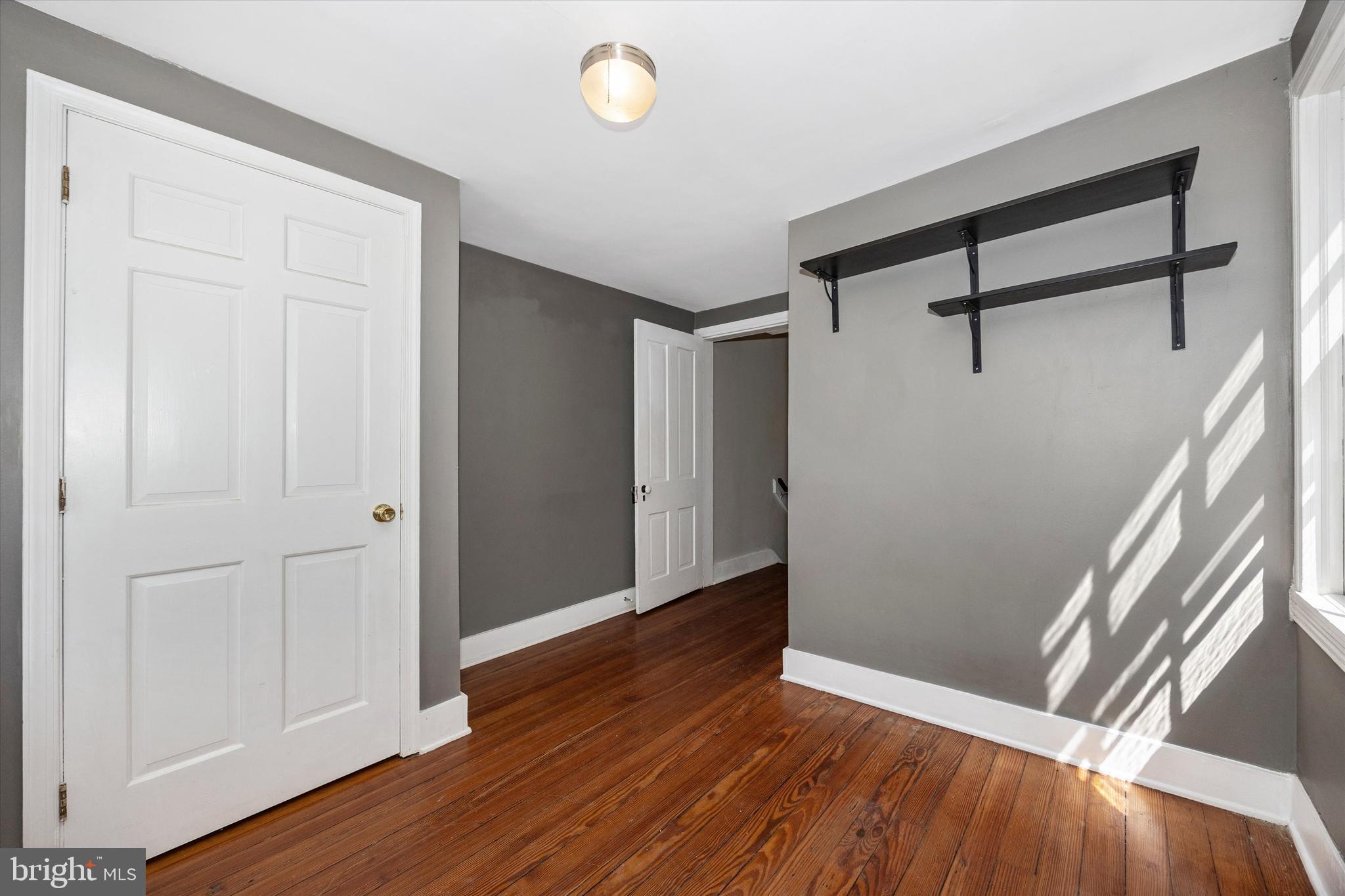 20 East 4th Street Frederick, MD 21701 - Photo 45 of 55 an empty room with wooden floor and windows