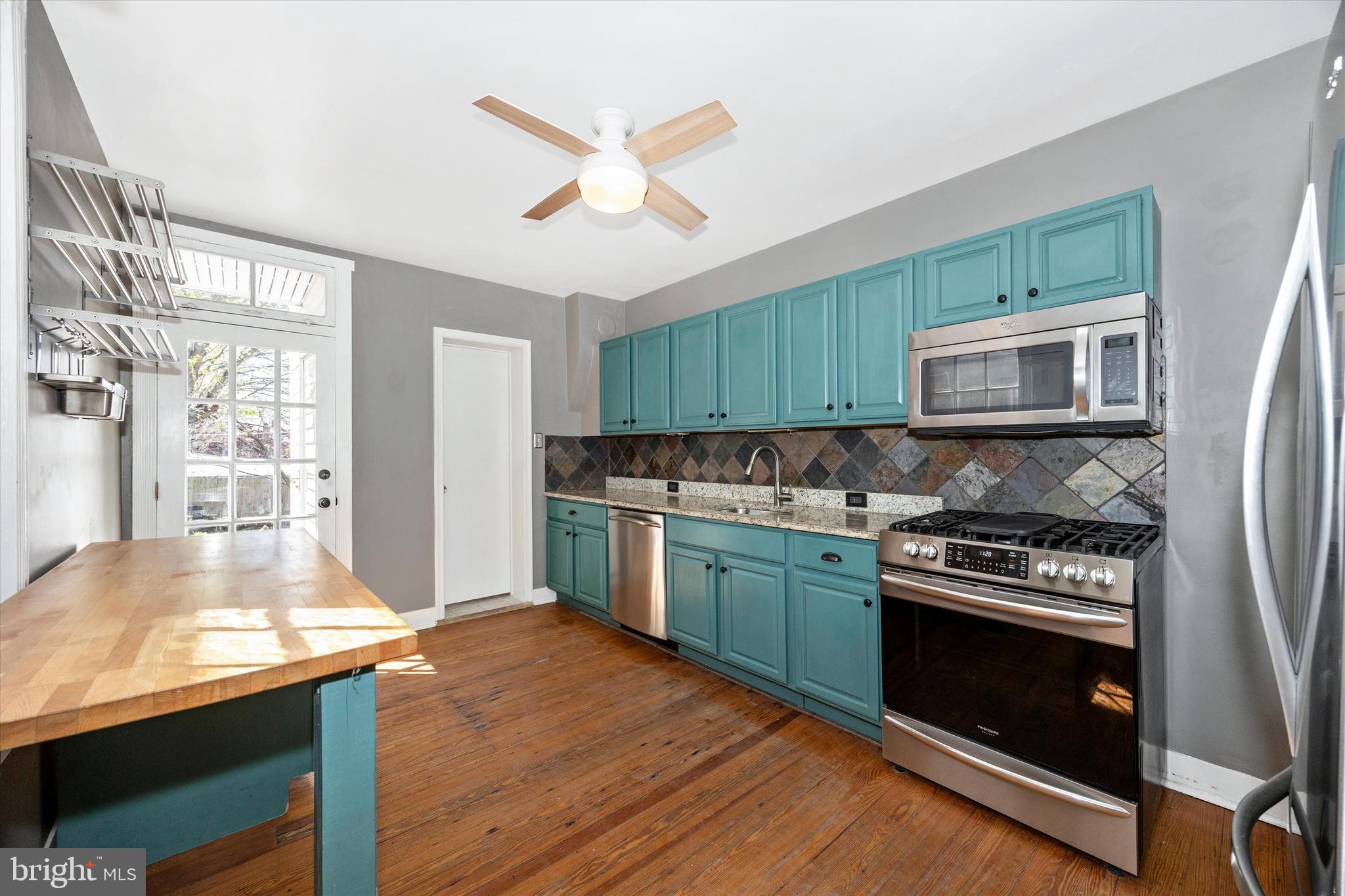 20 East 4th Street Frederick, MD 21701 - Photo 6 of 55 a kitchen with granite countertop wooden floors and stainless steel appliances