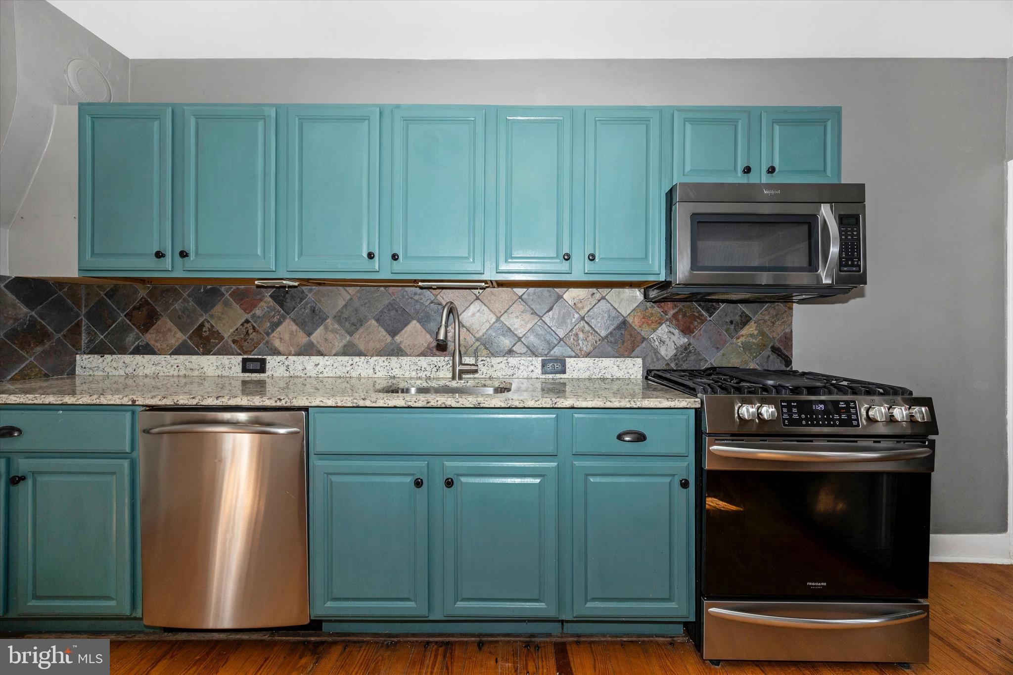 20 East 4th Street Frederick, MD 21701 - Photo 8 of 55 a kitchen with granite countertop wood cabinets and stainless steel appliances