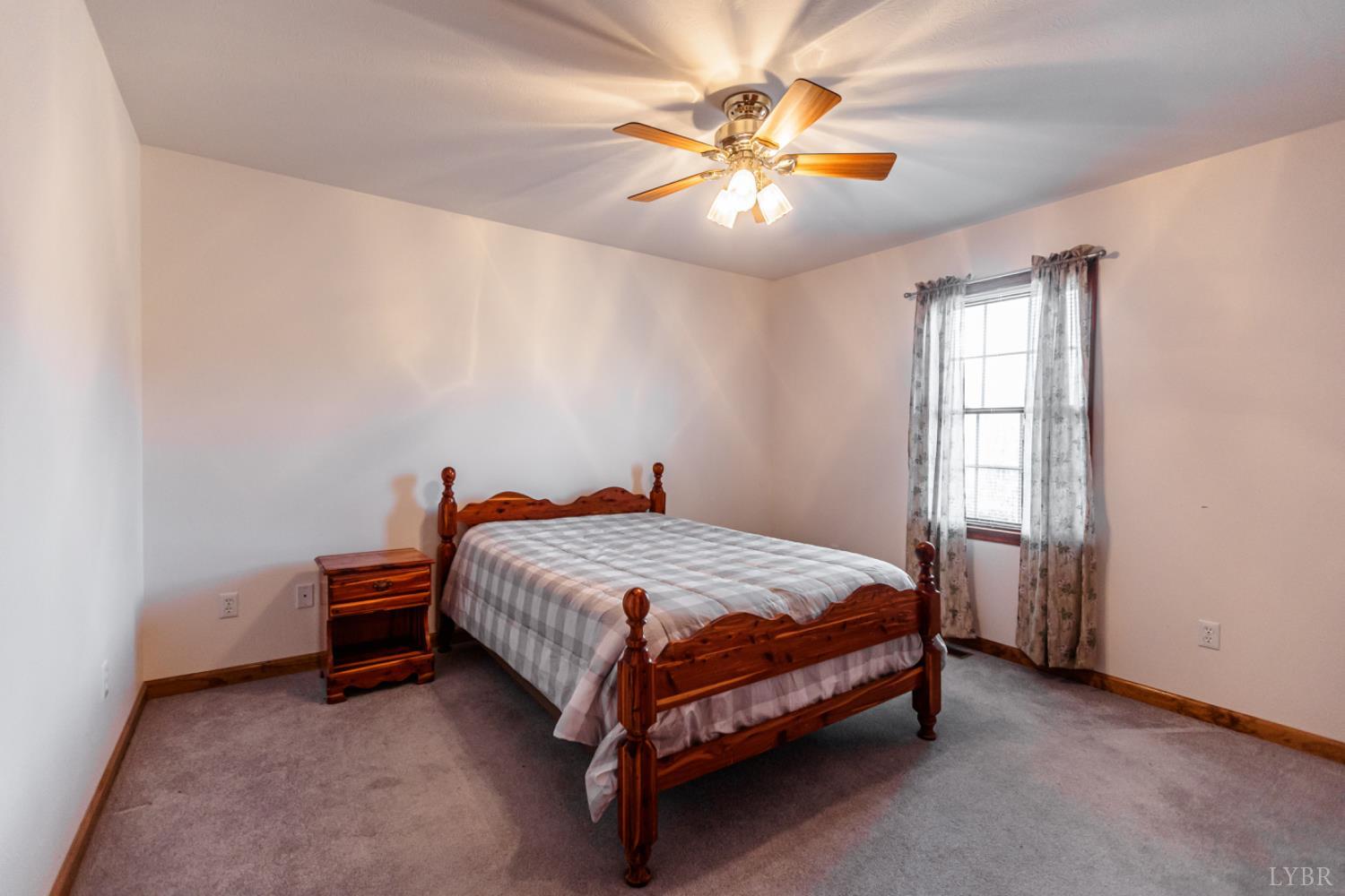 1975 Morning Star Road Appomattox, VA 24522 - Photo 14 of 29 a bed sitting in a room next to a window
