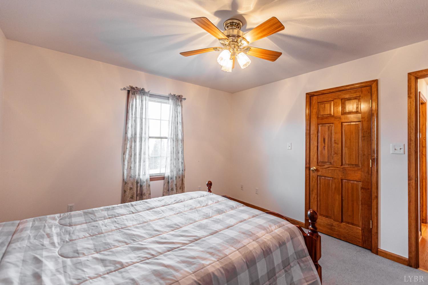 1975 Morning Star Road Appomattox, VA 24522 - Photo 15 of 29 a bedroom with a bed and a chandelier