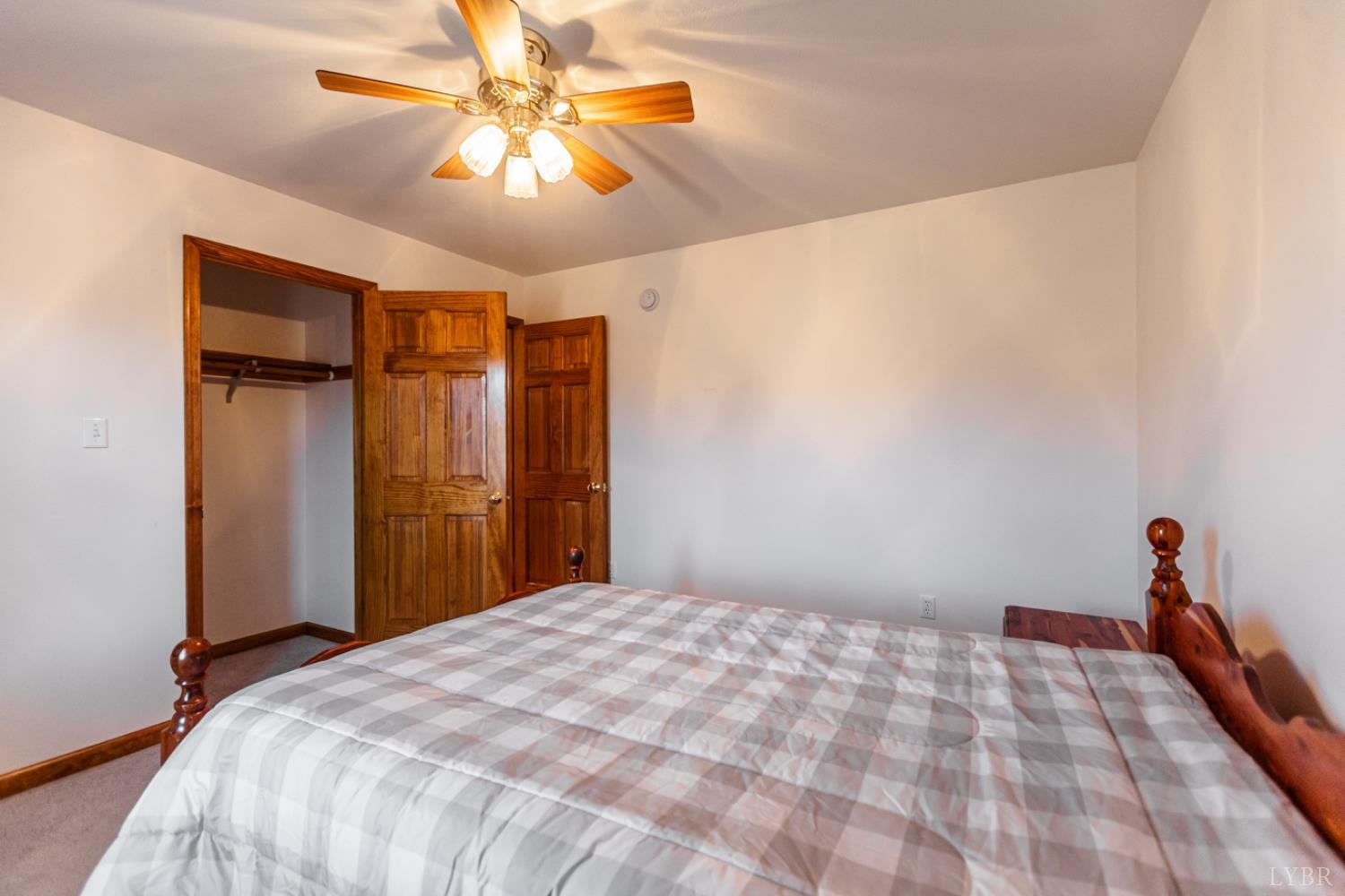 1975 Morning Star Road Appomattox, VA 24522 - Photo 16 of 29 a bedroom with a bed and a chandelier