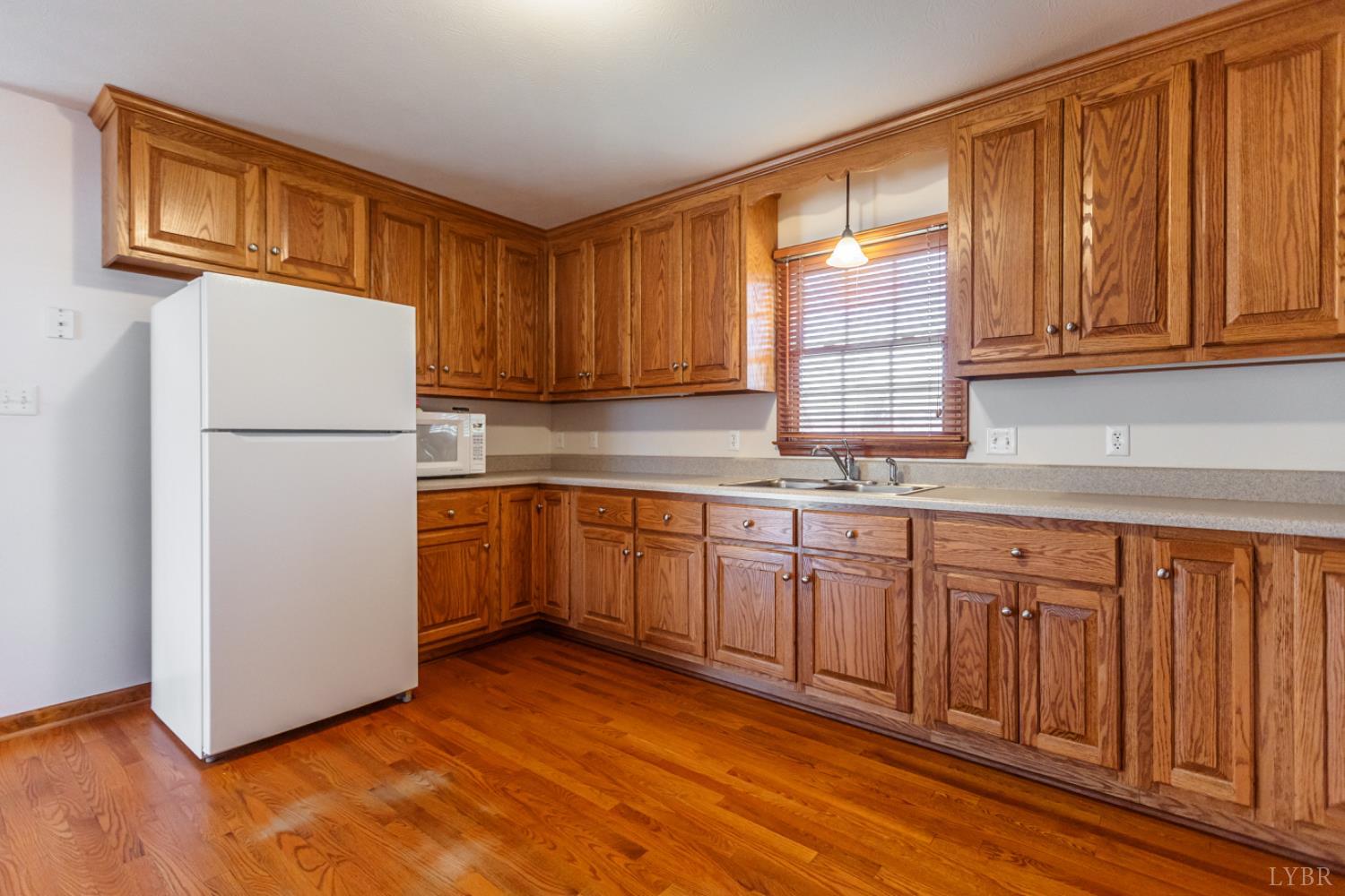 1975 Morning Star Road Appomattox, VA 24522 - Photo 7 of 29 a kitchen with granite countertop wooden cabinets and white appliances