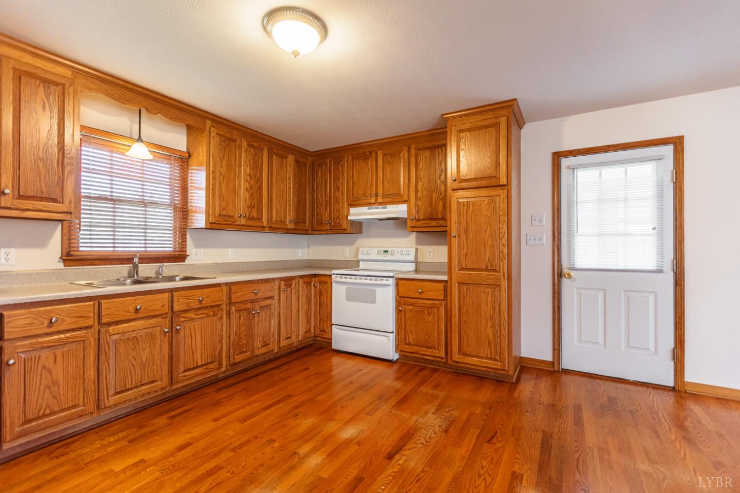 1975 Morning Star Road Appomattox, VA 24522 - Photo 8 of 29 a kitchen with a sink wooden cabinets and white appliances