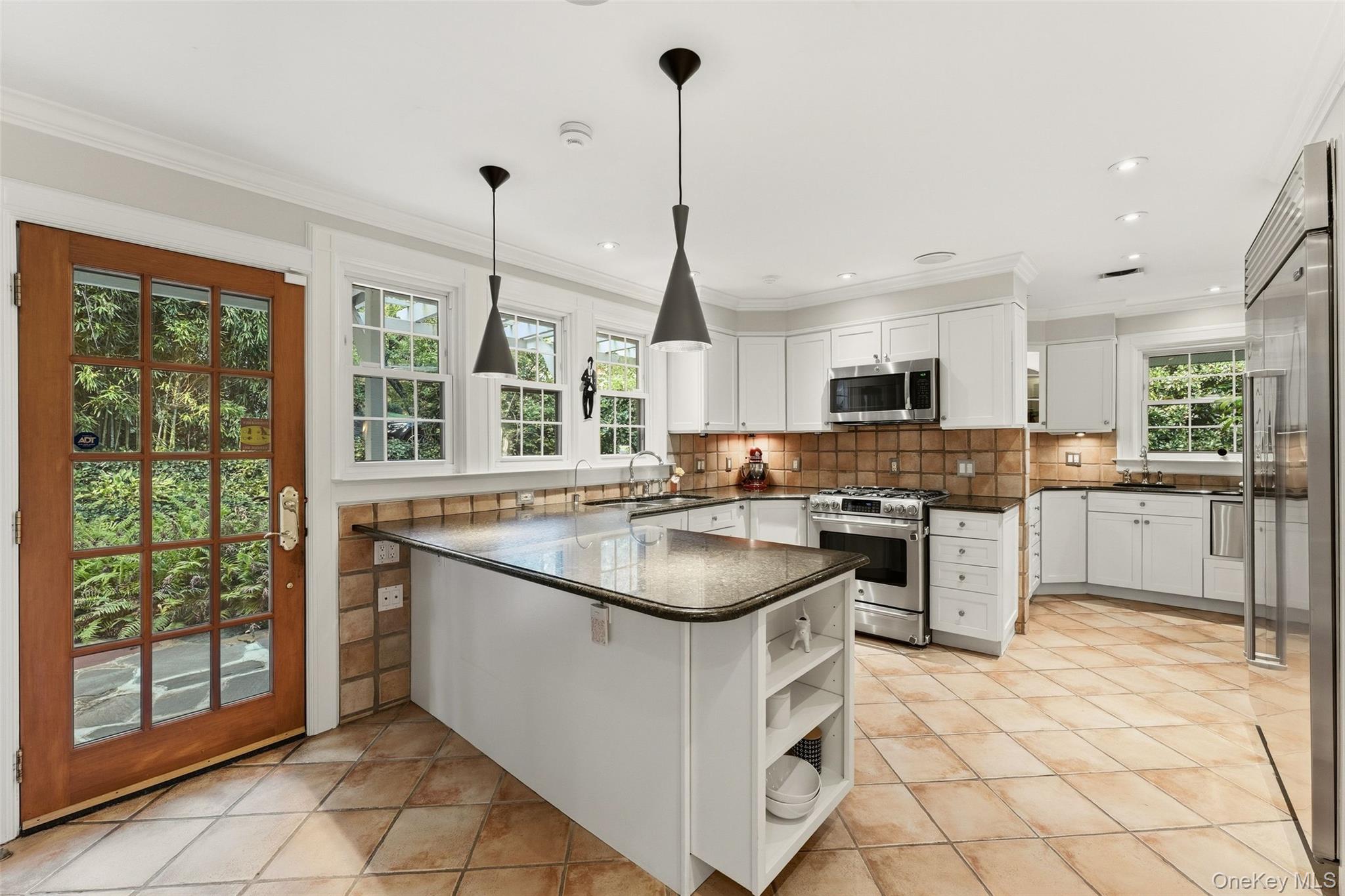 2 Dellwood Road Bronxville, NY 10708 - Photo 12 of 46 Dine-In Kitchen featuring stainless steel appliances, granite countertops, two sinks, custom cabinetry and access to the yard via the French Door.